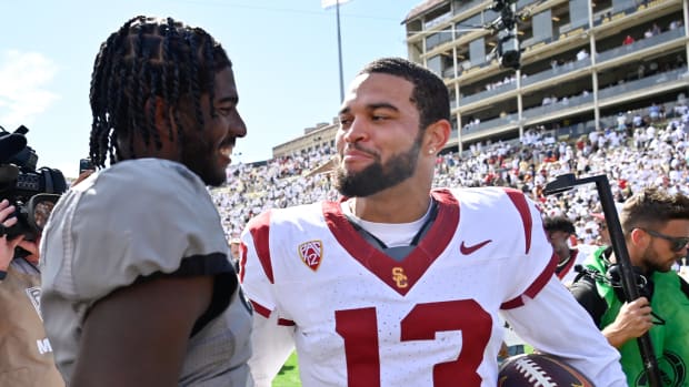 Colorado Buffaloes quarterback Shedeur Sanders (2) meets with USC Trojans quarterback Caleb Williams (13) after the game at Folsom Field